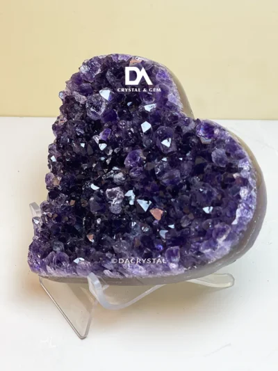 Purple Amethyst heart crystal stone with violet colour variations and a smooth polished finish Image Title: Purple Heart-Shaped Amethyst Stone